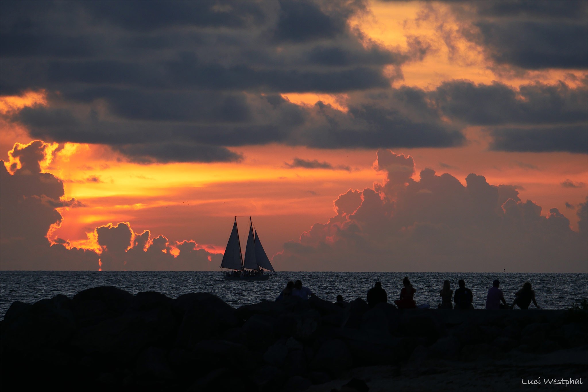 Silhouetted people watching sailboat at sunset, Fort Zachary Park, Key West, Happier Place Calendar
