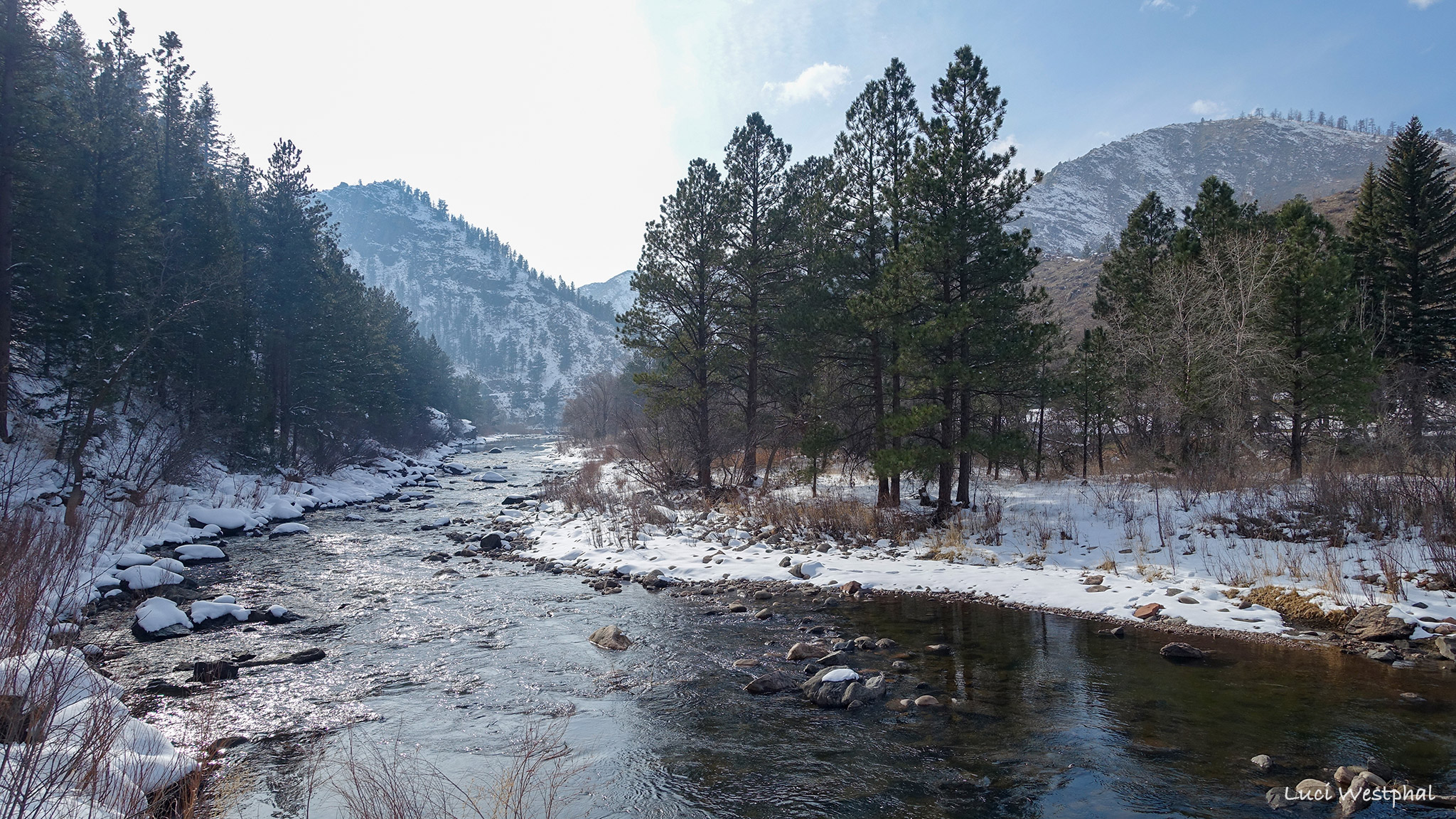 Winding Cache la Poudre River in winter, covered in snow, Poudre Canyon, Colorado