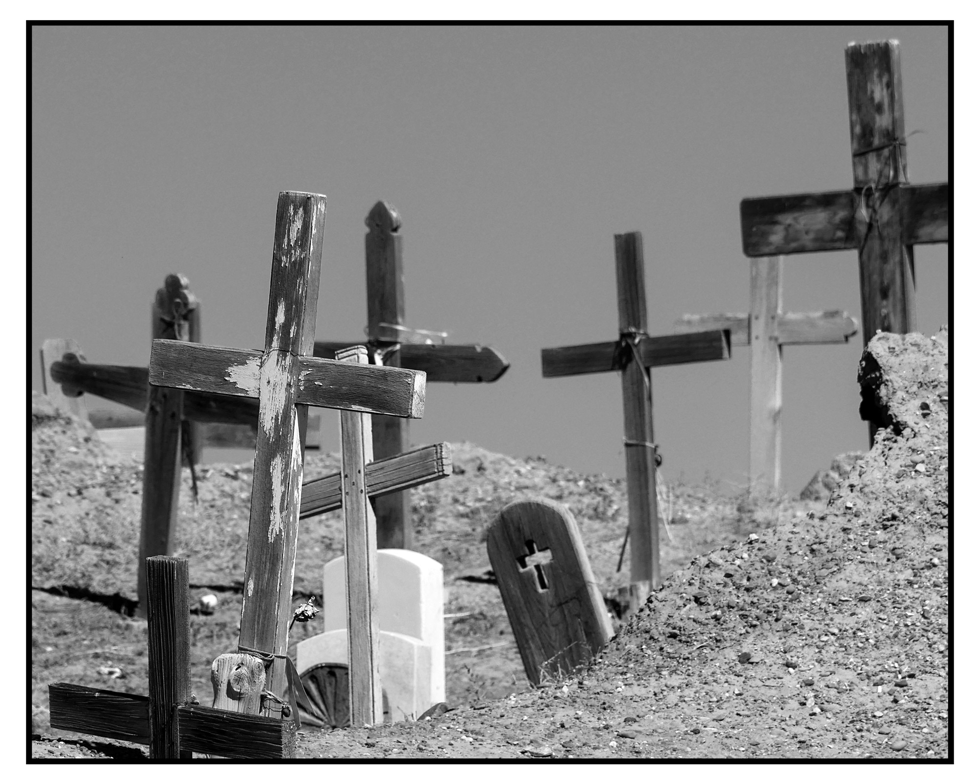 black and white photo of wooden crosses, Taos Pueblo cemetery, by Luci Westphal