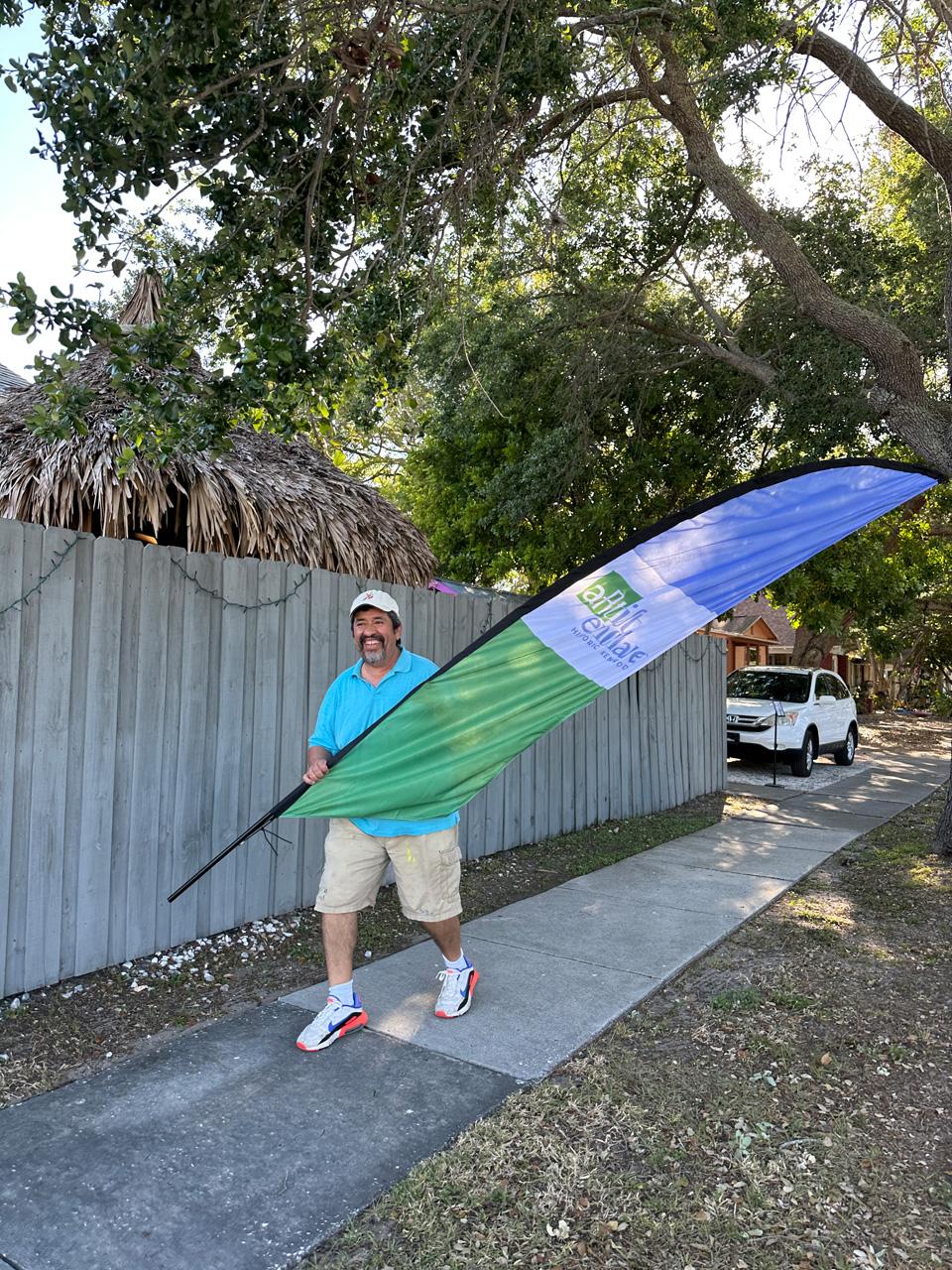 Paul Barrera carrying Historic Kenwood Kenwood Artist Enclave flag to set up in front of studio.