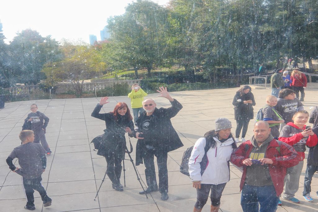 waving people reflection in The Bean (Cloud Gate) in Millennium Park Chicago, Luci and Guenter Westphal, daughter father photographers, artists